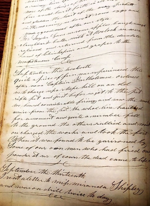 Cursive handwriting on a worn and aged page in a journal from the Civil War